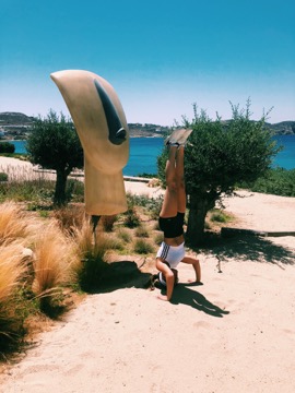 My signature headstand by a phallic statue in Mykonos.